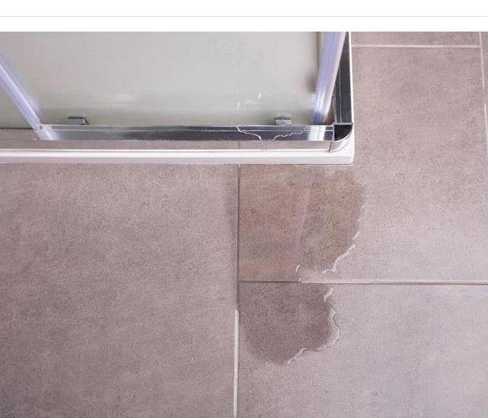 Water leakage from a shower cubicle with damaged glass wall